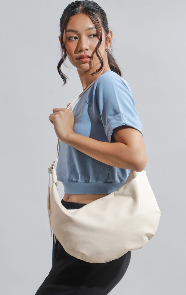 Campaign photo of the Off-White Faux Leather Dumpling Shoulder Bag worn by a model with outfit 