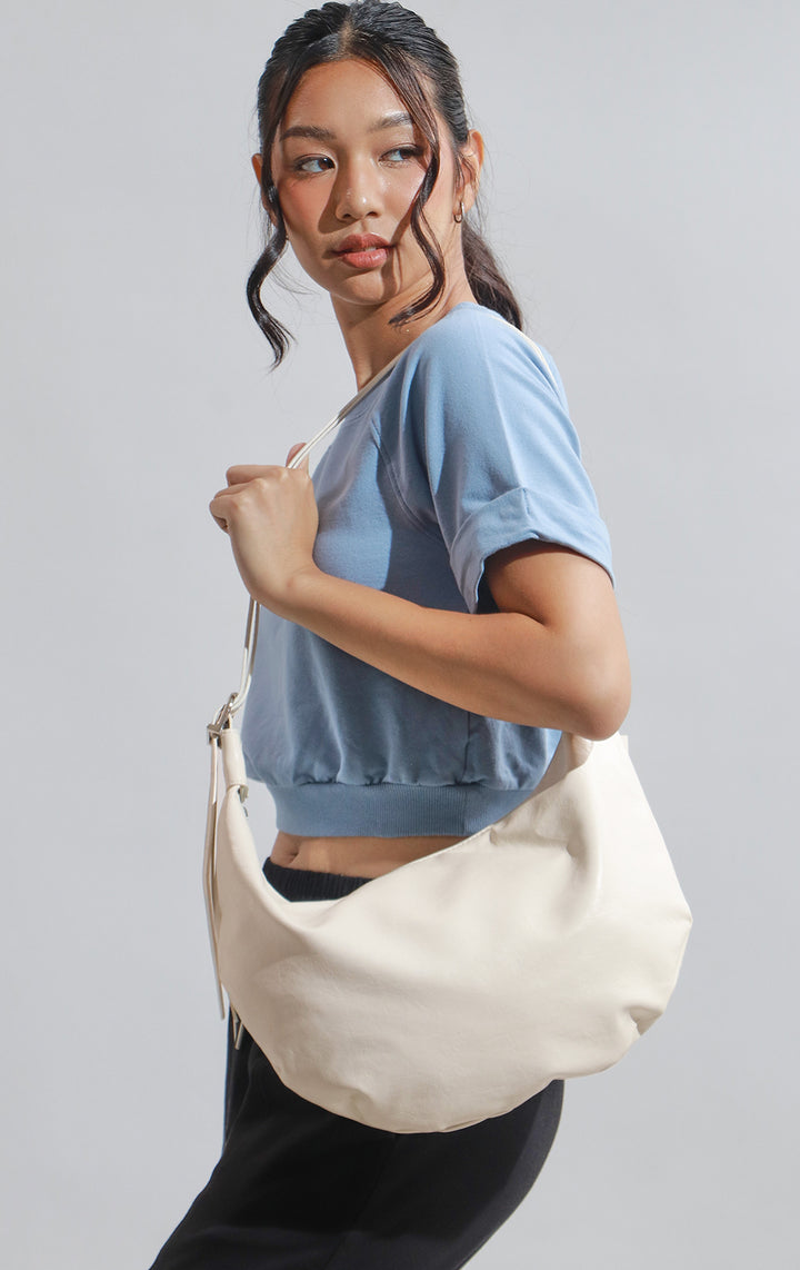 Campaign photo of the Off-White Faux Leather Dumpling Shoulder Bag worn by a model with outfit 