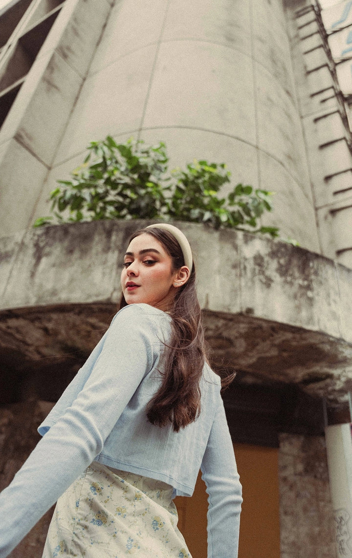 Campaign photo of a woman wearing the Cotton Fleece Round Neck Tee with Extended Shoulder and Ribbing in blue from Just G Philippines, a Gen Z fashion brand.