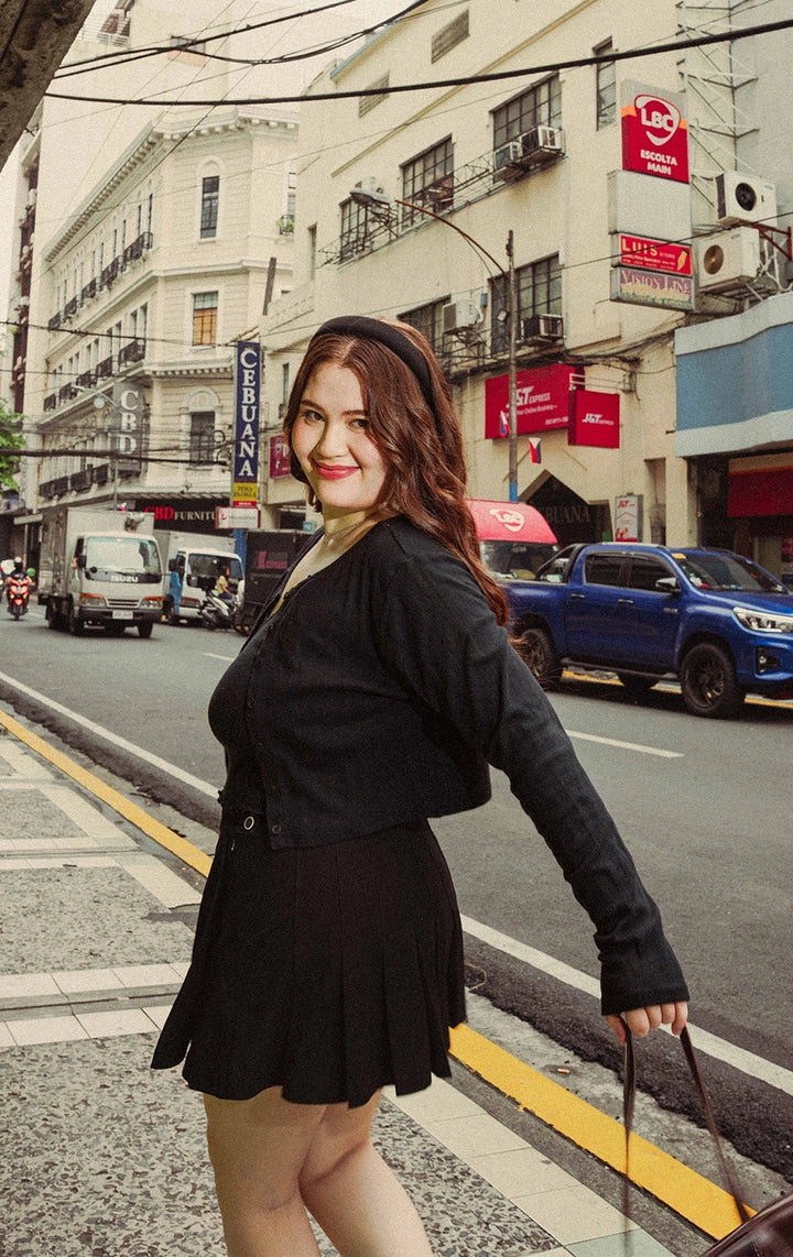 Campaign photo of a woman wearing the Cotton Fleece Round Neck Tee with Extended Shoulder and Ribbing in black from Just G Philippines, a Gen Z fashion brand.
