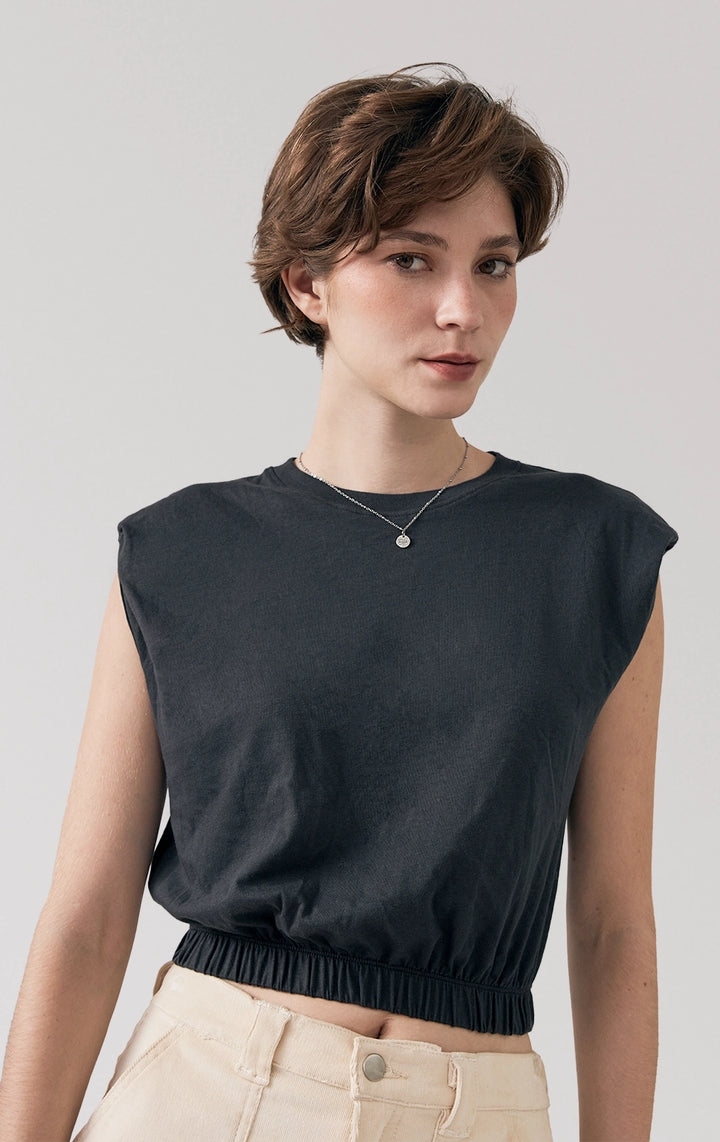Stylized photo of model wearing the black Single Jersey Cropped Muscle Tee, styled casually from Just G Philippines’ Back to School collection.