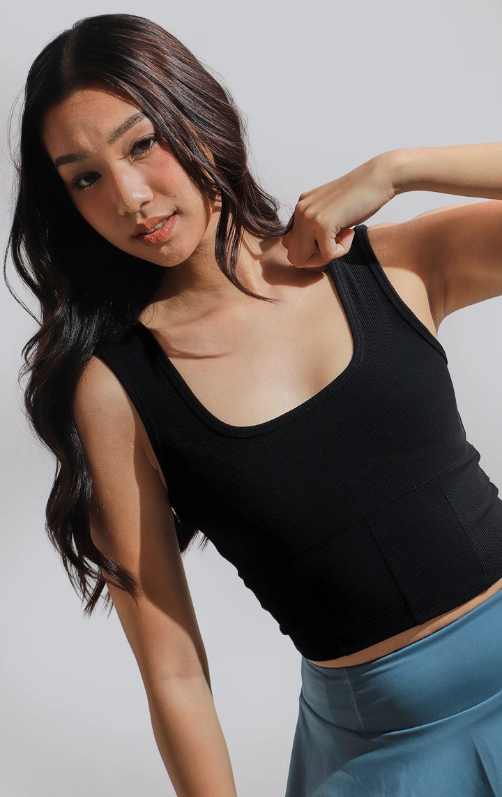 Stylized photo of model in black Ribbed Corsetry-Like Square Neck Tank Top by Just G Philippines, styled for an active, on-the-go look.