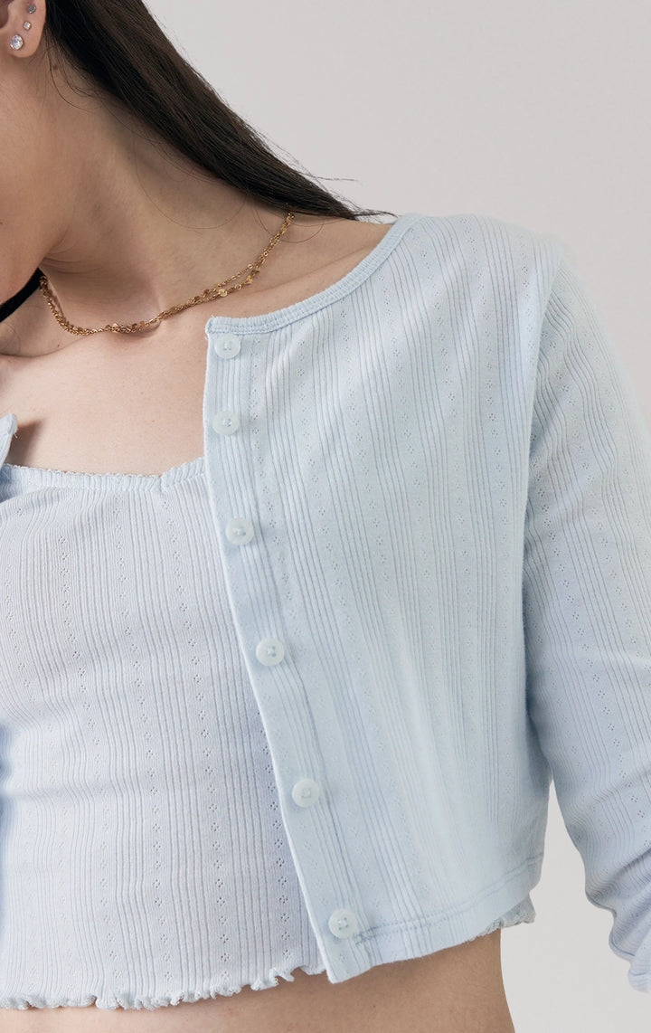Close-up of the front details of the Pointelle Ribbed Jersey Long Sleeve Cropped Cardigan in blue by Just G Philippines, featuring button accents and fine ribbing.