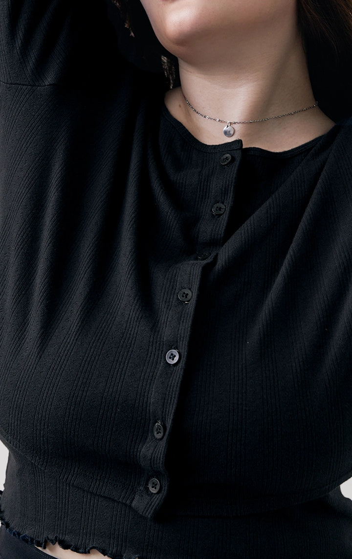 Close-up of the front details of the Pointelle Ribbed Jersey Long Sleeve Cropped Cardigan in black by Just G Philippines, featuring button accents and fine ribbing.