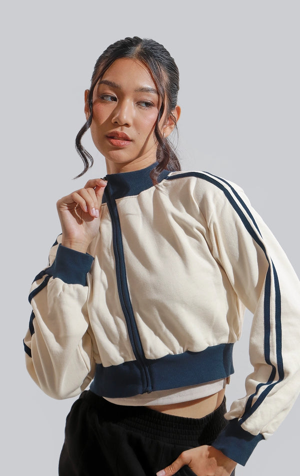 Stylized image of Brushed Terry Cropped Zip-Up Track Jacket in eggnog and blue from Just G Philippines, styled for girls on the go.