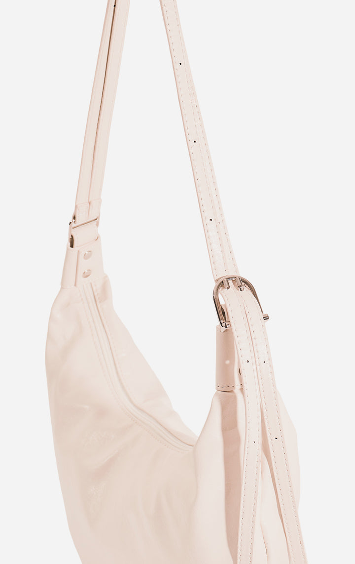 Stylized photo of the Off-White Faux Leather Dumpling Shoulder Bag on minimal setup