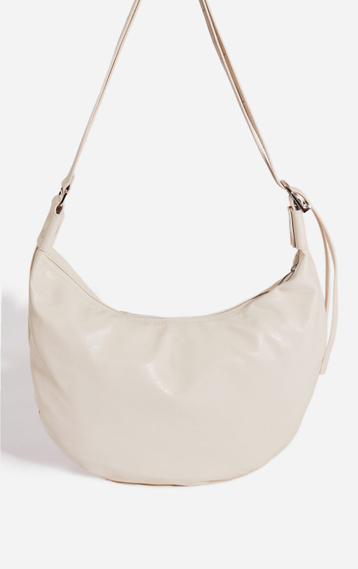 Close-up of the material and handle on the Off-White Faux Leather Dumpling Shoulder Bag