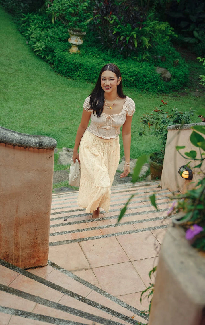 Campaign photo of the textured dobby milkmaid top with ruffle and smocking detail that shows how it looks when worn, from the Just G Love In Bloom collection