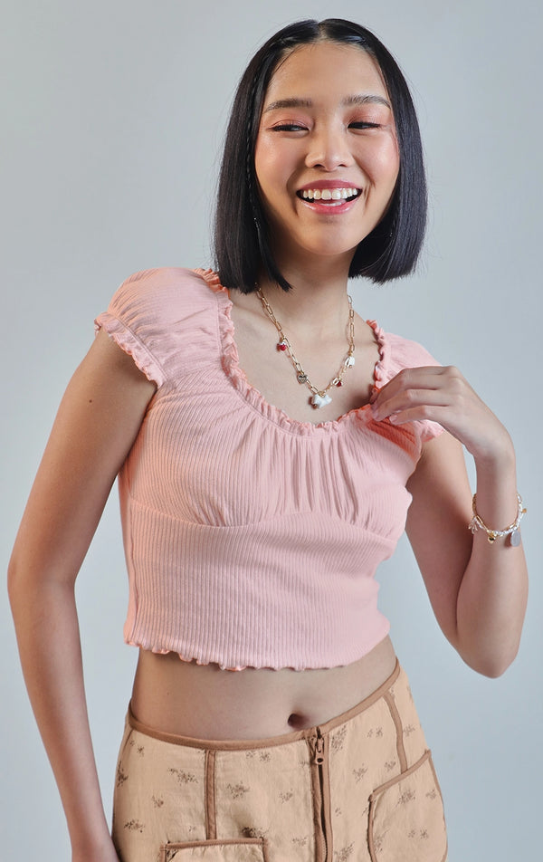 Front detail close-up of the pointelle jersey ruffled milkmaid puff sleeve top focusing on the ruffled neckline and puff sleeve seams by Just G Philippines