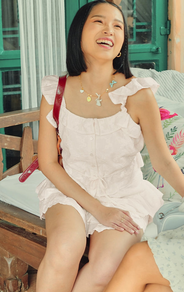 Campaign photo of the embroidered ruffle tiered skort set with ruffle sleeves, ruffled neckline, and tiered skort that shows how it looks when worn, from the Just G Love In Bloom collection