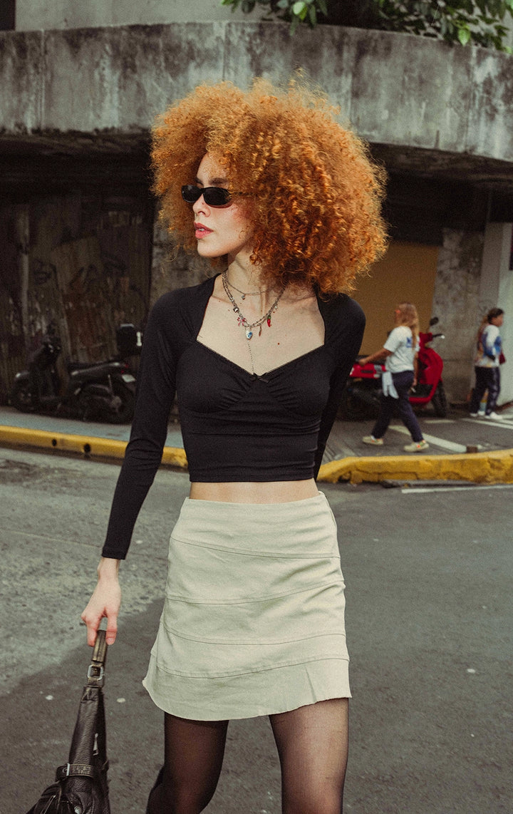 Campaign photo of the black long sleeve sweetheart top with lace and bow that shows how it looks when worn, from the Just G Urban Flora collection