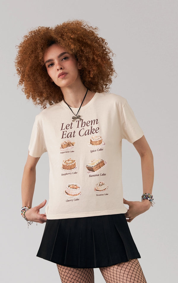 A stylized fashion photo of the regular fit tee with cake graphics that is worn with bottoms and accessories by a model to see it in motion