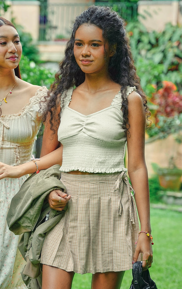 Campaign photo of the pointelle jersey tank top with ruffled straps and smocked bodice that shows how it looks when worn, from the Just G Love In Bloom collection
