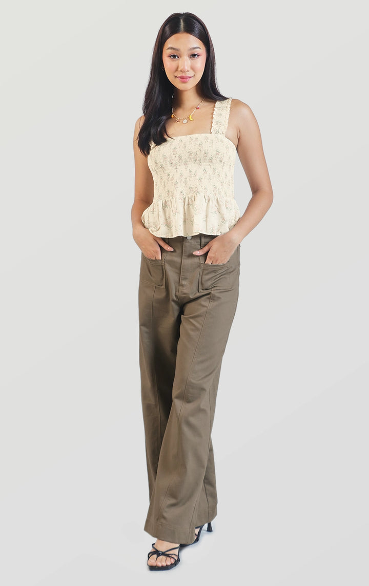 Full front view of the floral smocked peplum top showing the smocked bodice, sleeveless design, and square neckline by Just G Philippines