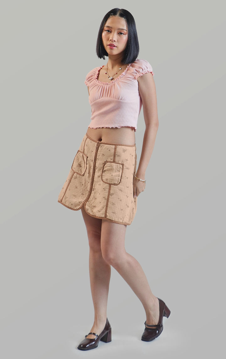 Full front view of the zip up a-line floral mini skirt showing the floral pattern and contrast piping by Just G Philippines