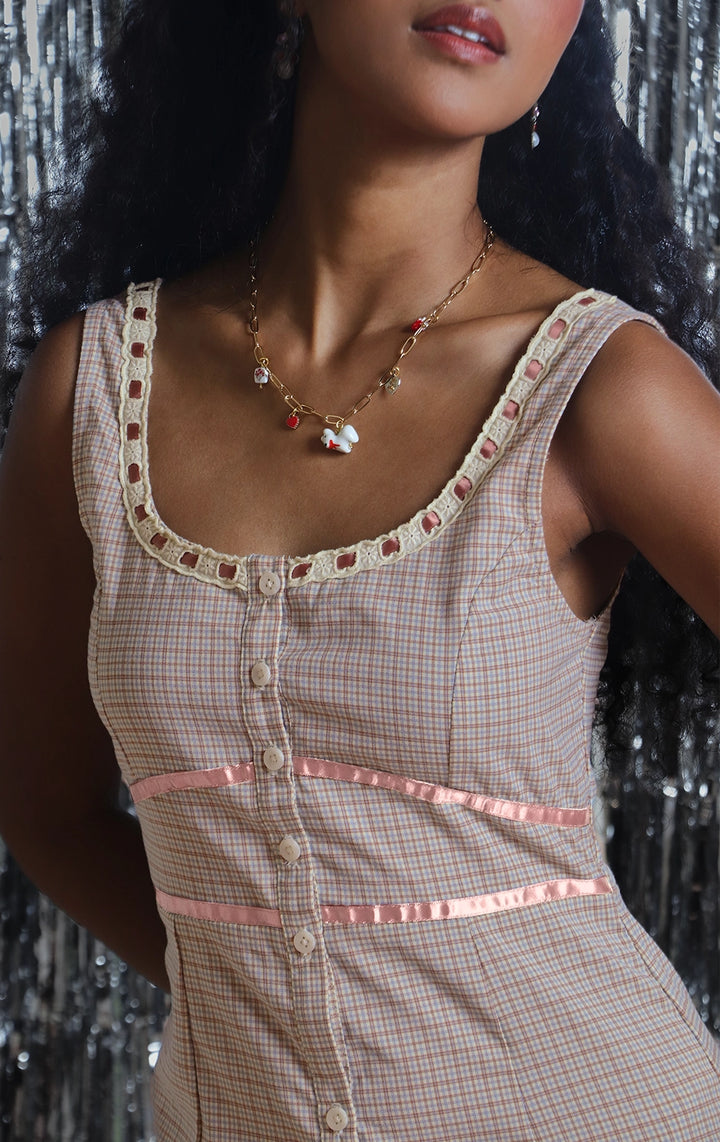 Front detail close-up of the checkered fabric, button closure, and contrast piping details by Just G Philippines