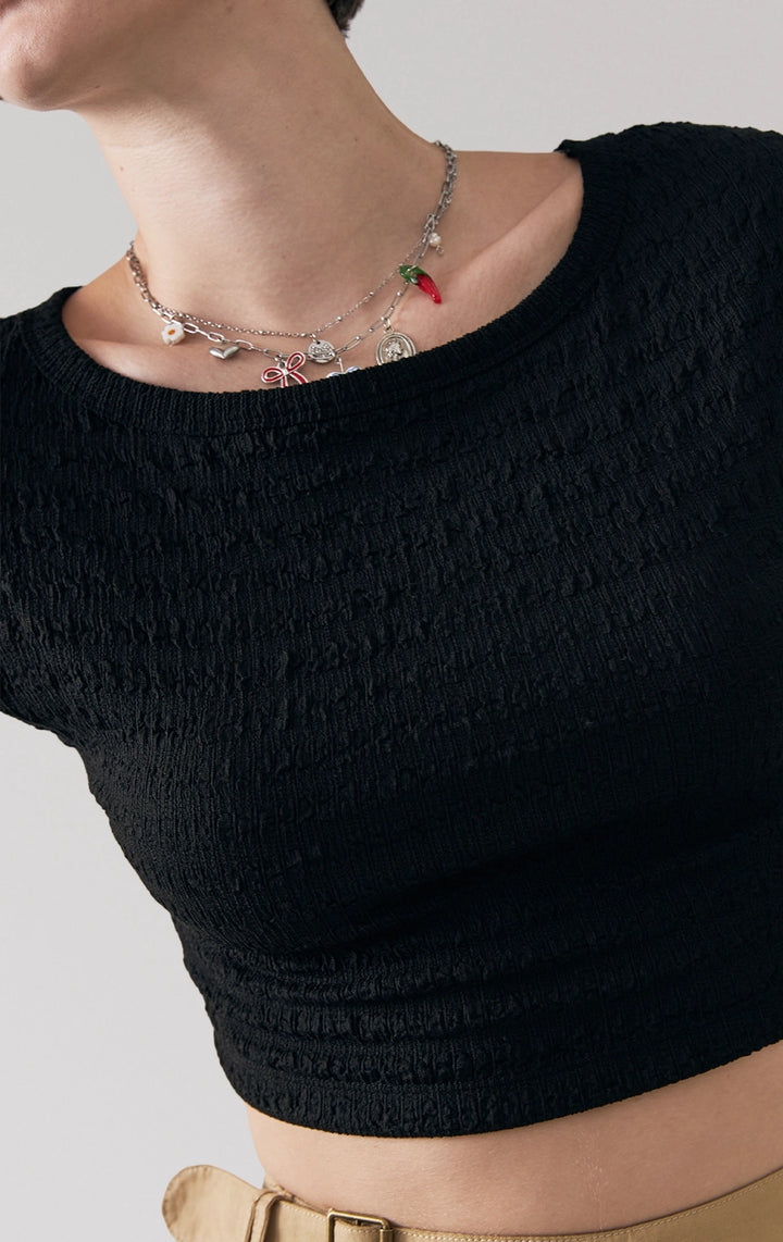 Front detail close-up of the boat neckline and crumpled jersey texture on the black baby tee by Just G Philippines