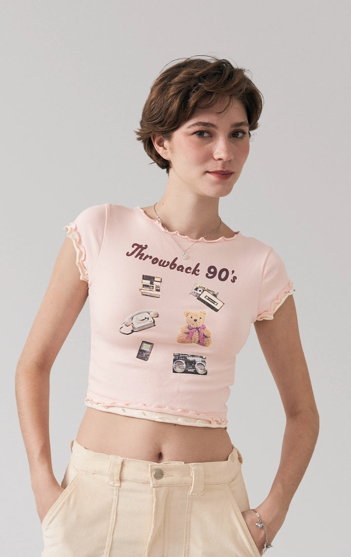 A stylized fashion photo of the lettuce edge tee with throwback 90's graphic that is worn with bottoms and accessories by a model to see it in motion