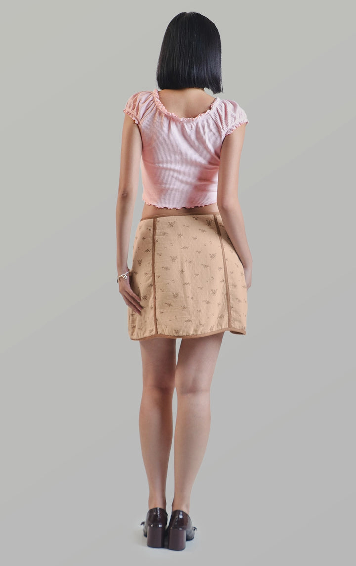 Full back view of the zip up a-line floral mini skirt with contrast piping detail showing the smooth A-line silhouette by Just G Philippines