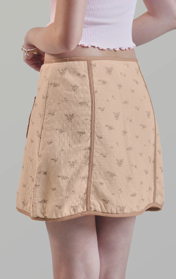 Full back view of the zip up a-line floral mini skirt with contrast piping detail showing the smooth A-line silhouette by Just G Philippines