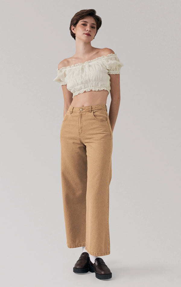 Full front view of a model wearing the smocked peasant crop top with tie detail and short sleeves by Just G Philippines