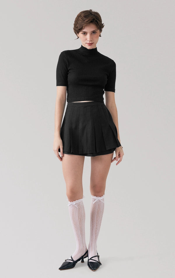 Full front view of a model wearing the jersey knit mock neck crop top with high neckline by Just G Philippines