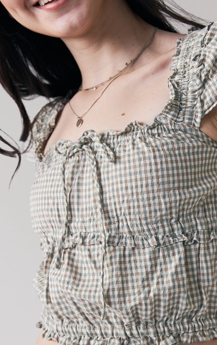 Close-up of front details of Checkered Smocked Top with Flutter Sleeves, featuring checkered fabric and flutter sleeve trim. From Just G Philippines.