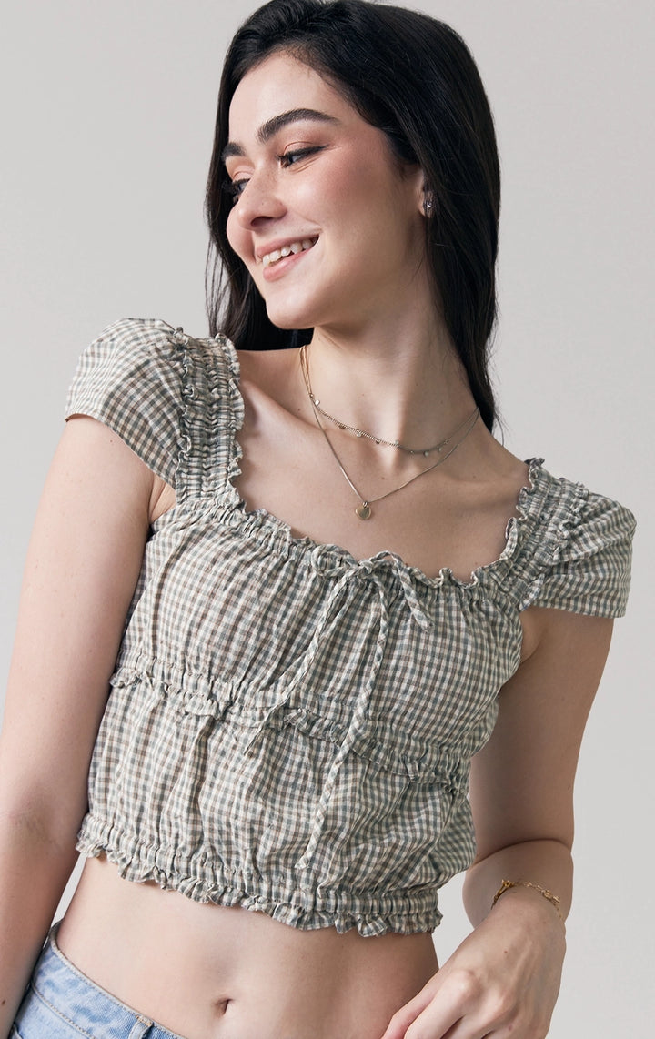 Stylized photo of model wearing the Checkered Smocked Top with Flutter Sleeves, styled for casual comfort from Just G Philippines' Back to School collection.