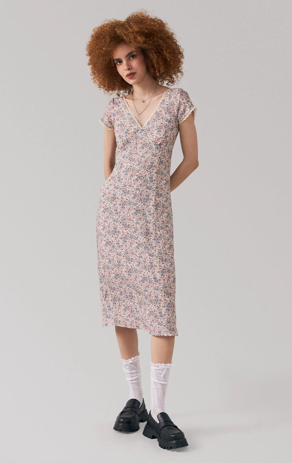 Full front view of a model wearing the floral midi dress with lace-trimmed v-neckline and short sleeves by Just G Philippines