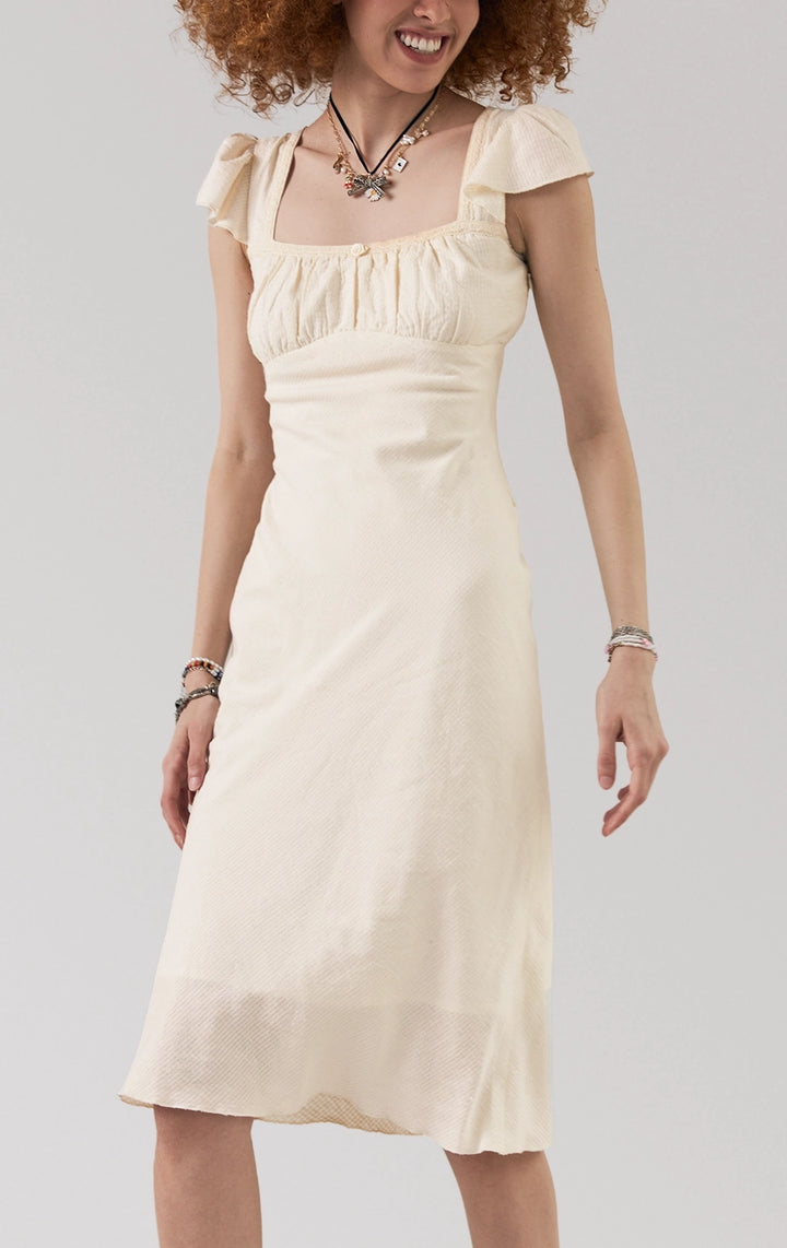 Stylized photo of Flutter Sleeve Symmetrical Hem Midi Dress from Just G Philippines’ Back to School collection, elegant, flowy, and made to stand out.