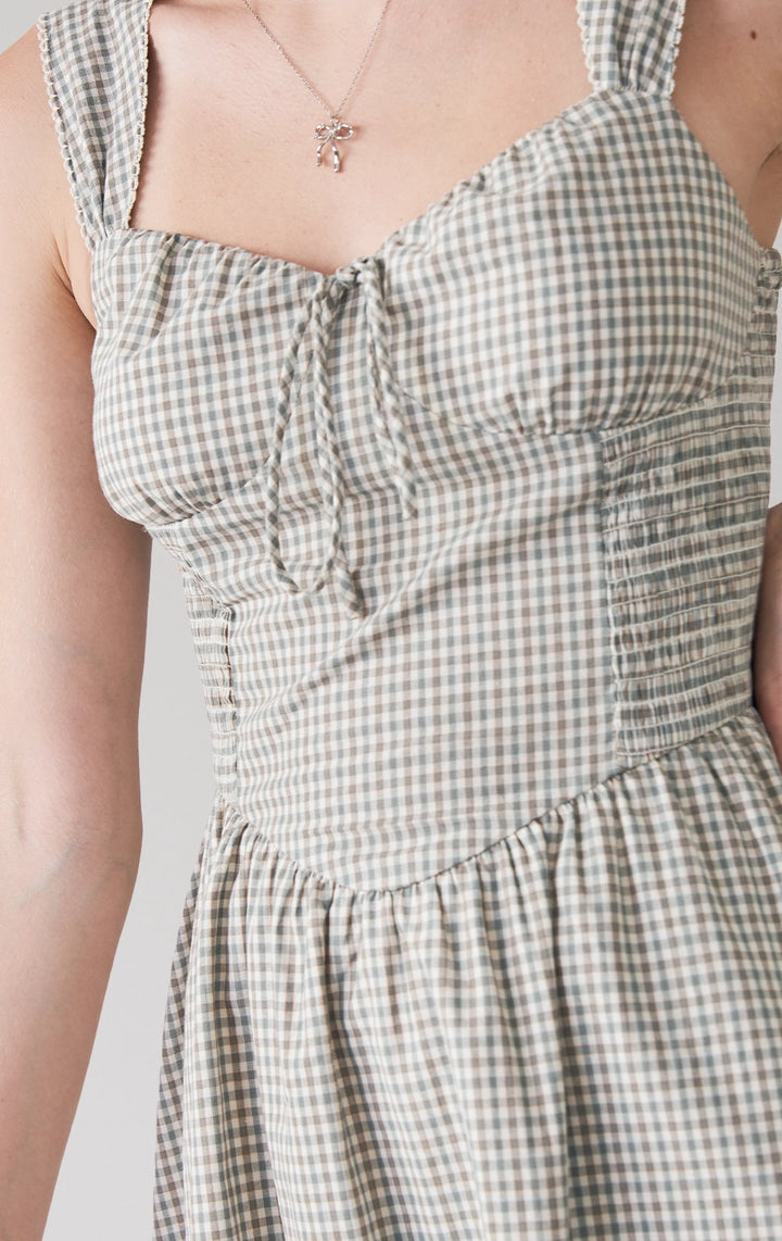 Close-up of front details of Checkered Corset-Like Dress with Smocking, showing lace-trimmed neckline and checkered texture. From Just G Philippines.