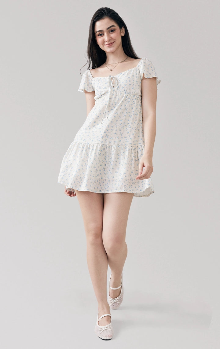 Full front view of woman in Floral Print Tiered Short Dress, featuring short sleeves, a V-neckline, and flowy layered skirt. From Just G Philippines.