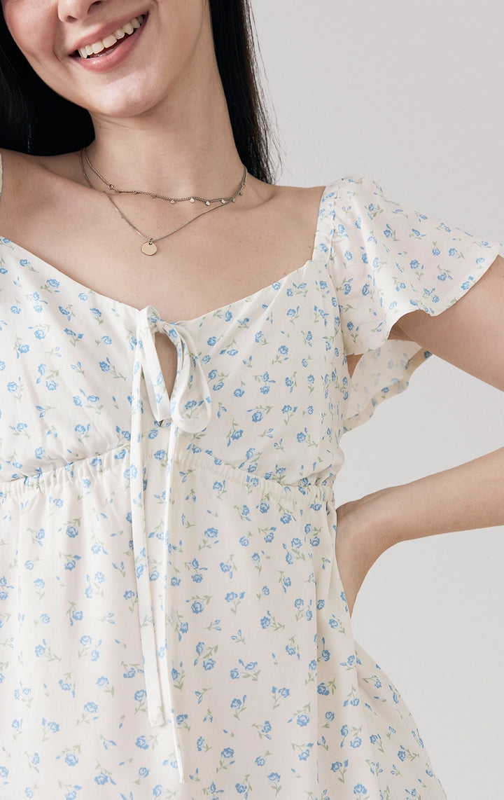 Close-up of front details of Floral Print Tiered Short Dress, highlighting floral pattern, V-neckline, and soft viscose fabric. From Just G Philippines.