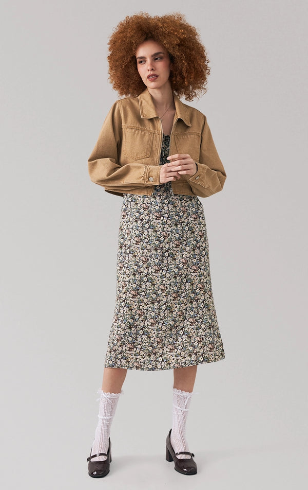 Full front view of a model wearing the cropped tan denim jacket with collared neckline and long sleeves by Just G Philippines
