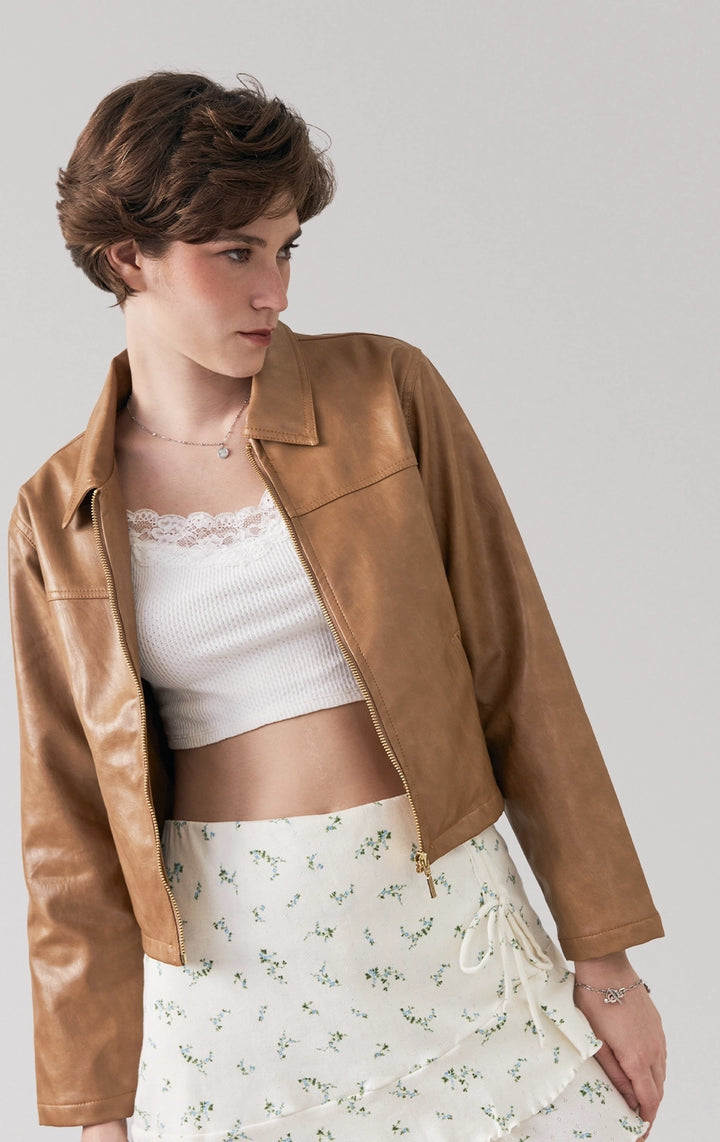 Stylized photo of model wearing the Oiled Leather Wide Collar Zip-Up Jacket for women, from the Back to School collection, for a bold city-ready outfit from Just G Philippines.