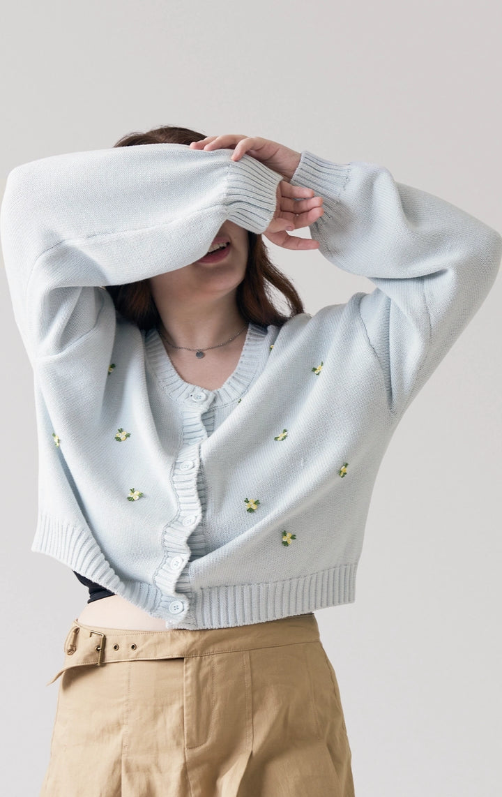Stylized photo of model in the Chunky Knit Cardigan With Flower Bullion Embroidery from the Back to School collection, paired for a cozy campus-ready look from Just G Philippines.