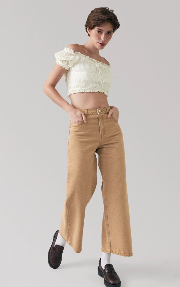 Full front view of a model wearing the tan denim wide pants with high waist and wide leg silhouette by Just G Philippines