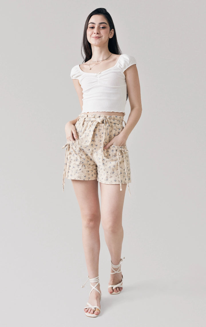 Full front view of the Floral Print Peached Canvas Paperbag Shorts, highlighting the high-rise waist, soft canvas fabric, and ribbon-trimmed pockets from Just G Philippines.