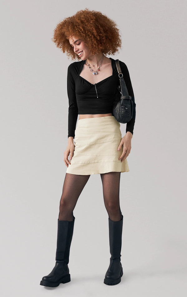 Full front view of a model wearing the cut and sew short skirt with above-the-knee hem by Just G Philippines