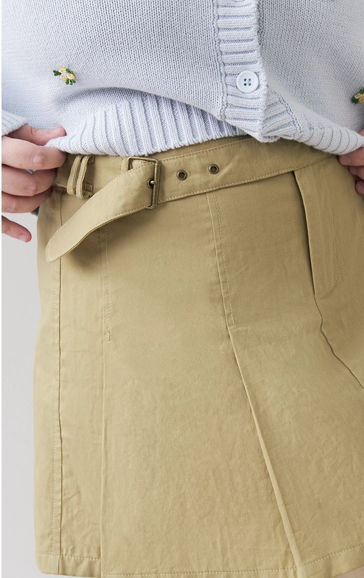 Close-up of front details of the Belted Pleated Mid Waist Skort in green, featuring neat pleats and a tonal belt from Just G Philippines.