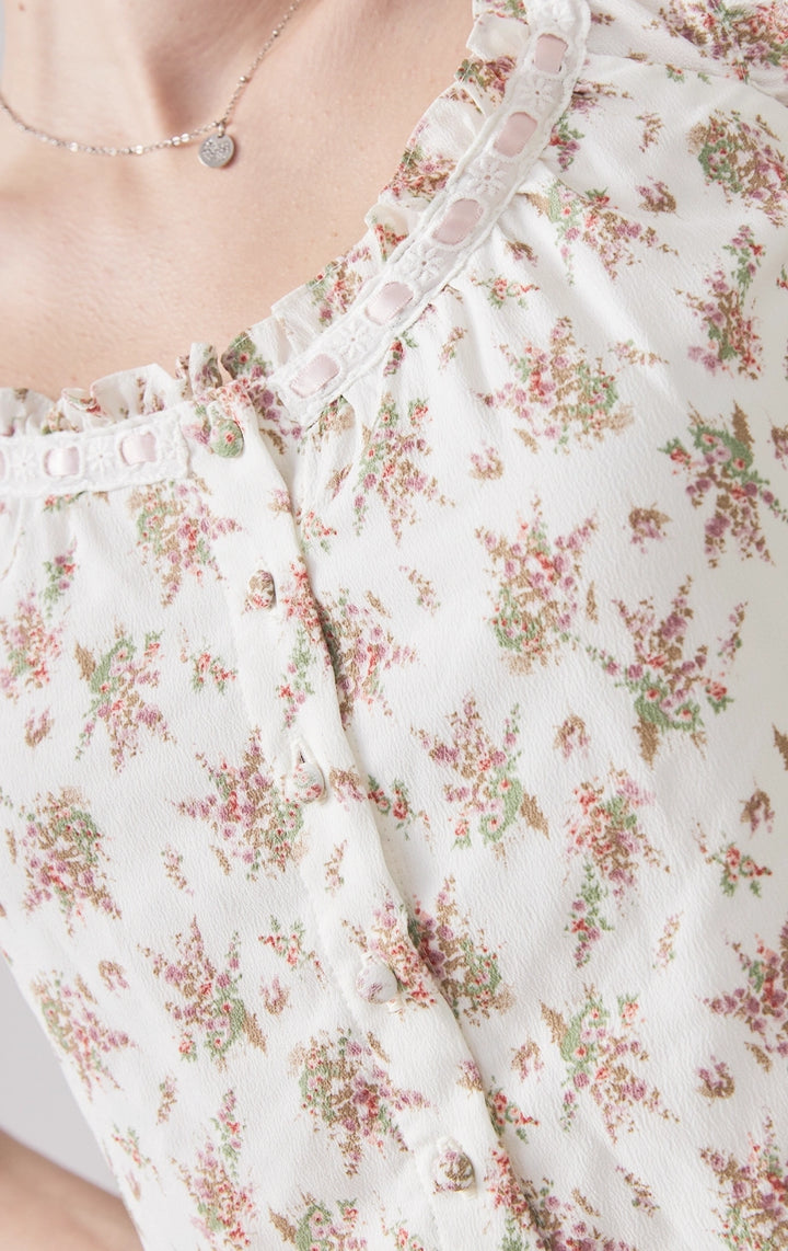 Close-up of front details of Floral Milkmaid Top with Ruffled Skort, showing lace accents and floral pattern. From Just G Philippines.