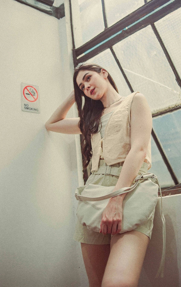 Campaign photo of woman wearing Cropped Linen-Like Tie Front Vest With Cross-Stitch Details And Lace in Beige from Gen Z brand Just G Philippines.